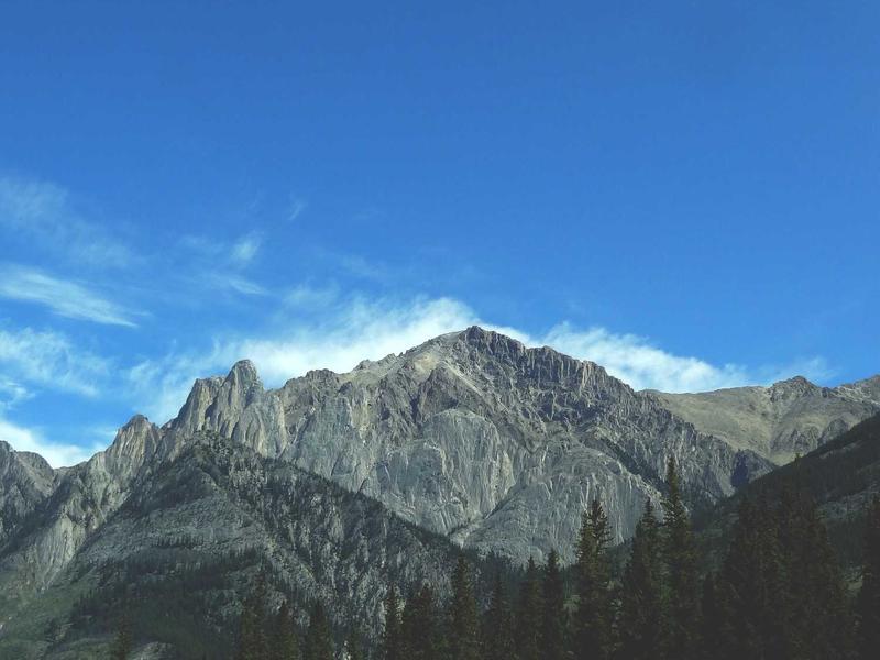 The Maple Suite with king four-poster bed, wood-burning fireplace, and river-view window seat